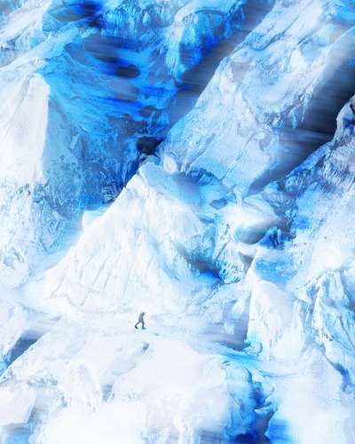 Climber navigating a vast icy Himalayan landscape for NNormal, highlighting scale, extreme conditions, and human endurance.